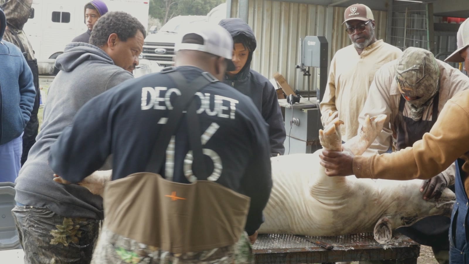 DeClouet family members working the hog