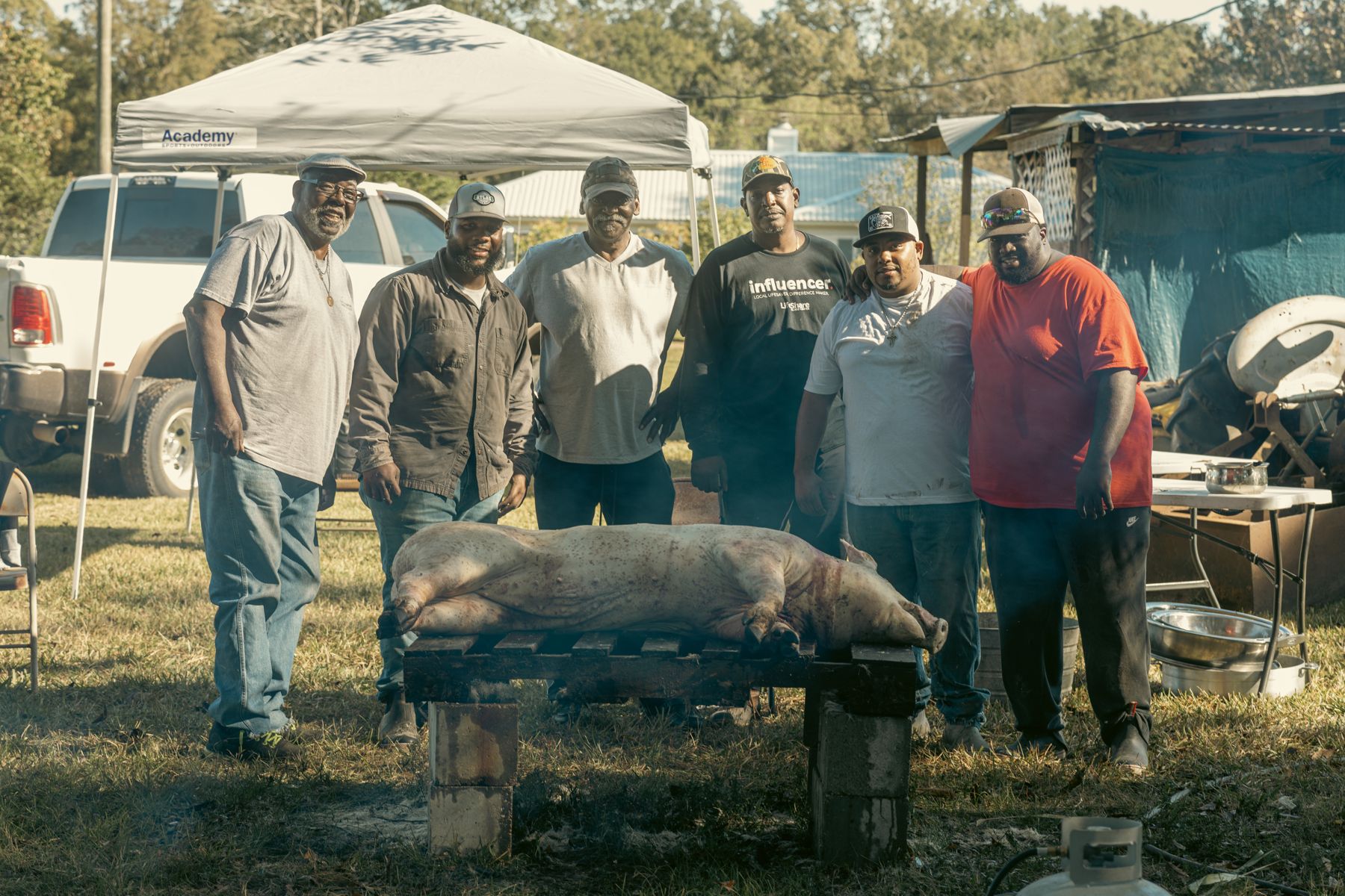 The crew gathered around the hog